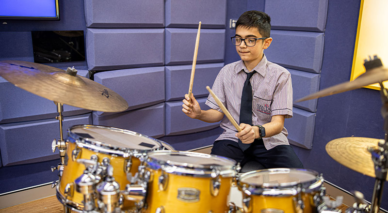Santa Sophia Catholic College Box Hill student playing drums