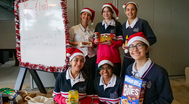 Santa Sophia Catholic College Box Hill students collecting food for christmas hampers