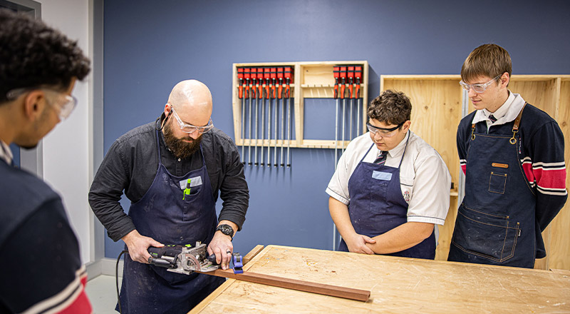 Santa Sophia Catholic College Box Hill dedicated teacher and student in a woodworks room