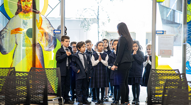Santa Sophia Catholic College Box Hill students entering a church
