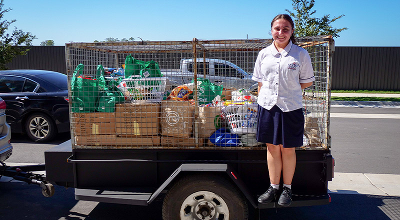 Santa Sophia Catholic College Box Hill student delivering goods to St Vincent de Paul