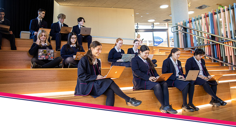 Santa Sophia Catholic College Box Hill students sitting on staircase