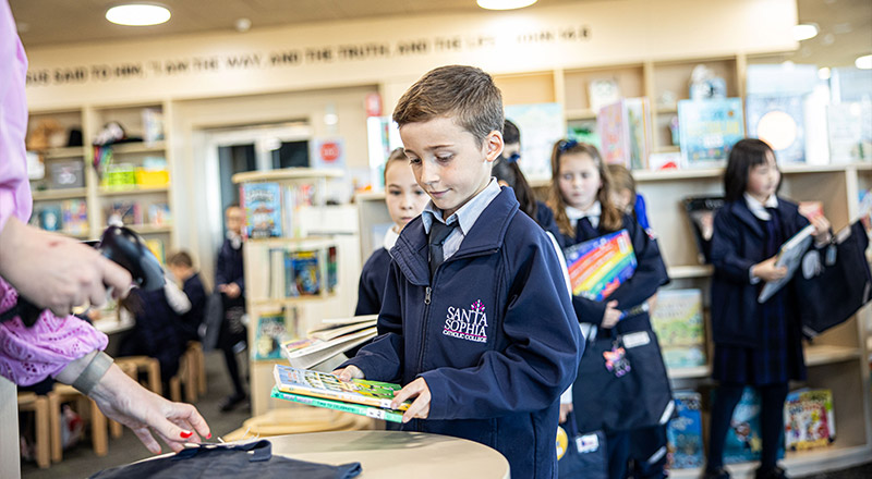 Santa Sophia Catholic College Box Hill student borrowing books from library