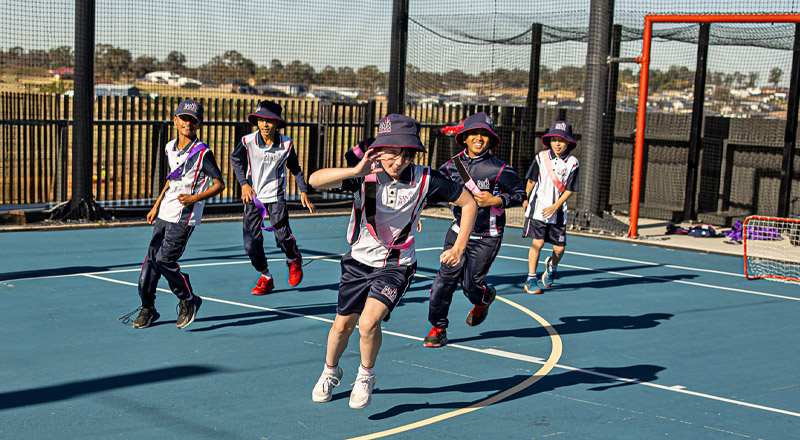 Santa Sophia Catholic College Box Hill students running around on basketball court