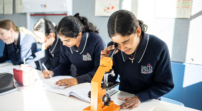 Santa Sophia Catholic College Box Hill student using microscope