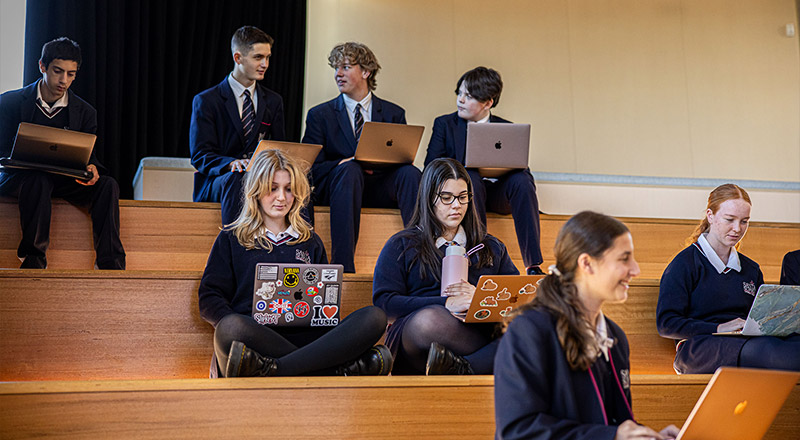 Santa Sophia Catholic College Box Hill students learning on staircase
