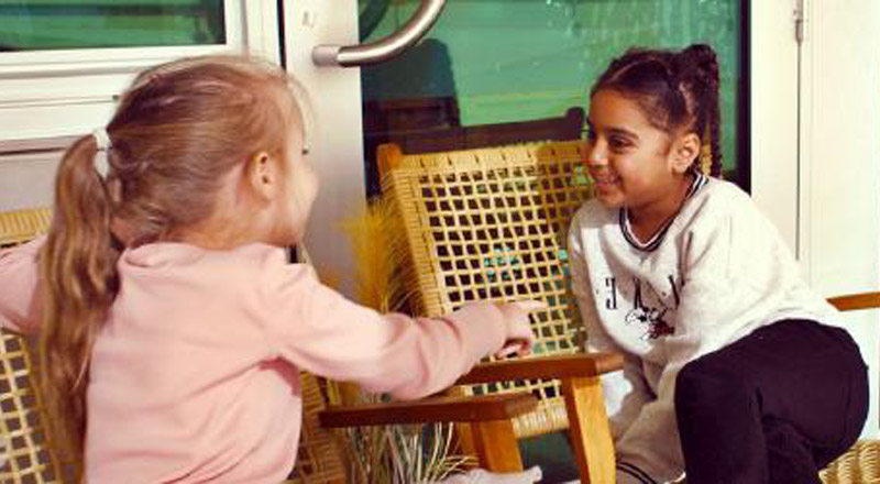 Two students sitting on a bench