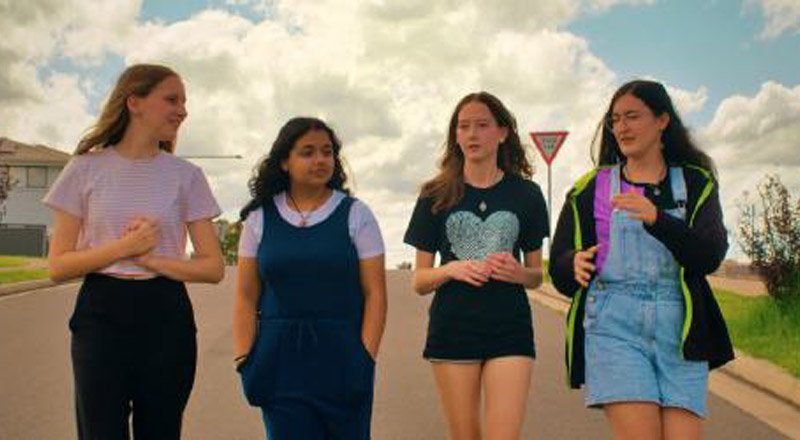 Four pre-teen's walking down a road
